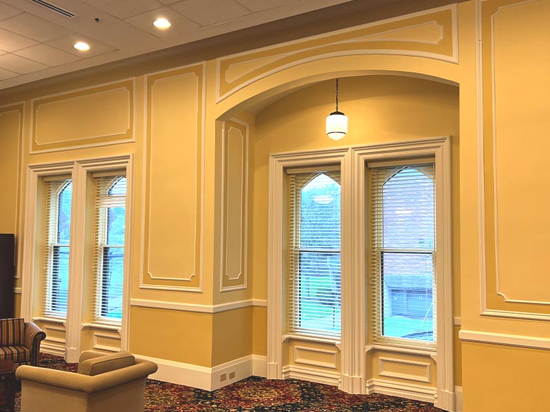 a room filled with furniture and a large window